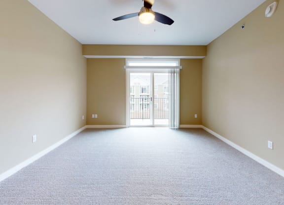 living room with a ceiling fan and 9' ceiling at Strathmore Apartment Homes, West Des Moines, 50266