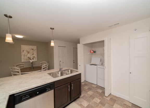 Kitchen With Dining and Washer Dryer Set at Strathmore Apartment Homes, Iowa, 50266