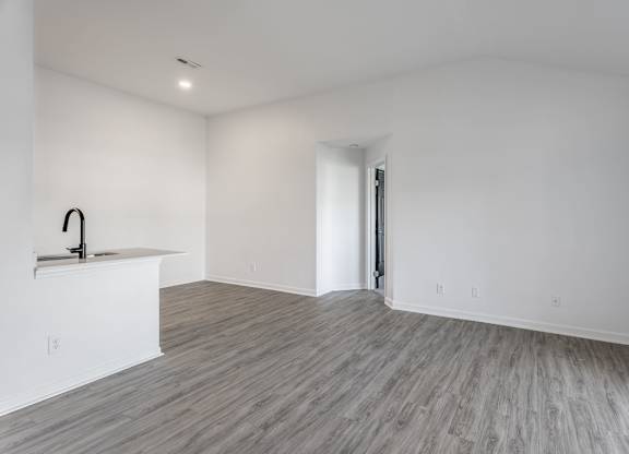 A room with a wooden floor and a sink. at Sundance Apartments, Indianapolis, Indiana