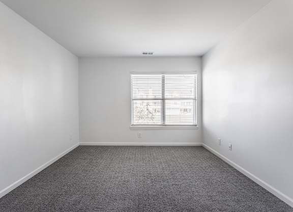 A room with a window and carpeted floor. at Sundance Apartments, Indianapolis