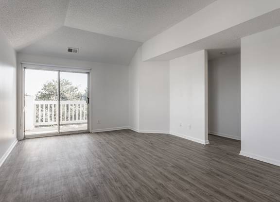 A room with a sliding glass door leading to a balcony. at Sundance Apartments, Indianapolis, IN