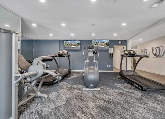 A gym with a treadmill, exercise bike, and weight machine. at Sunscape Apartments, Virginia, 24018