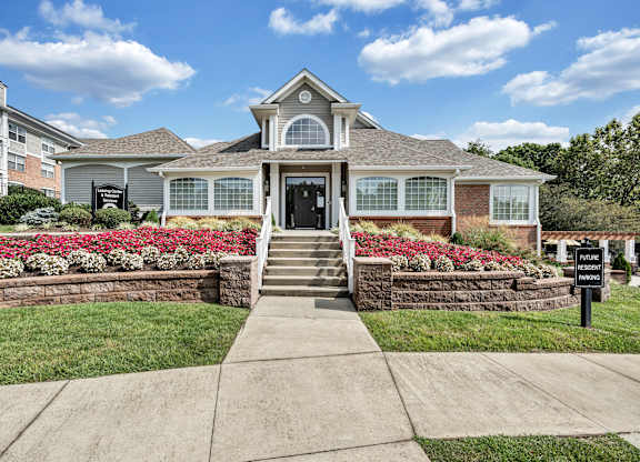A house with a front yard and a sign that says  at Sunscape Apartments, Virginia, 24018
