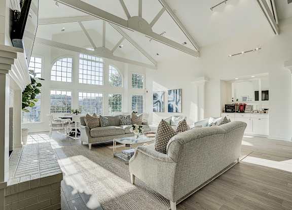 A living room with a couch and a television. at Sunscape Apartments, Virginia