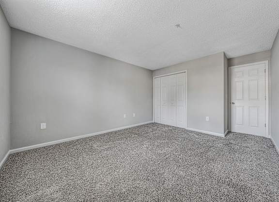 A room with grey carpet and white walls. at Sunscape Apartments, Roanoke, 24018