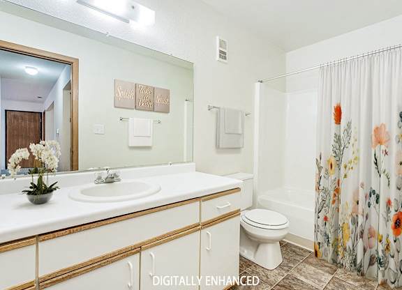 A bathroom with a sink, toilet, and shower at Tanglewood Apartments, Oak Creek