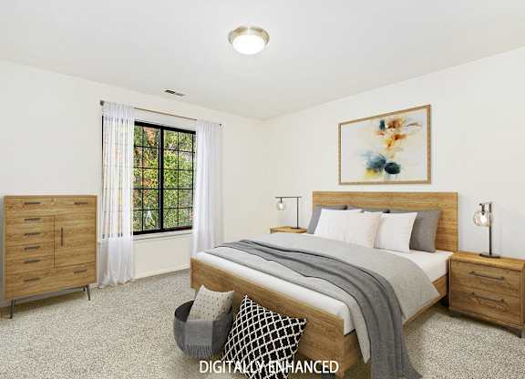 A spacious bedroom with a large bed and a window at Tanglewood Apartments, Oak Creek