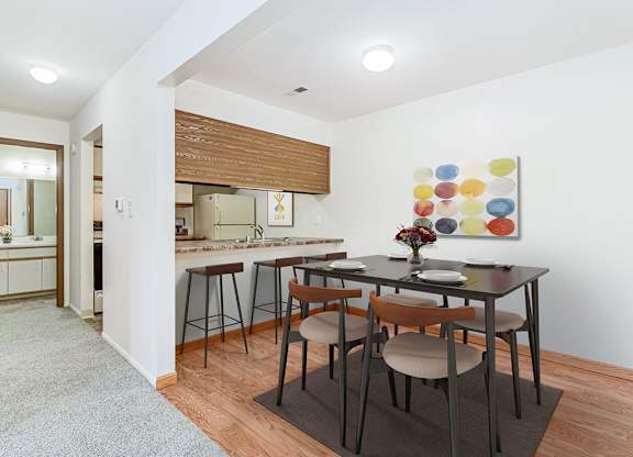 A kitchen and a dining table set for two at Tanglewood Apartments, Oak Creek