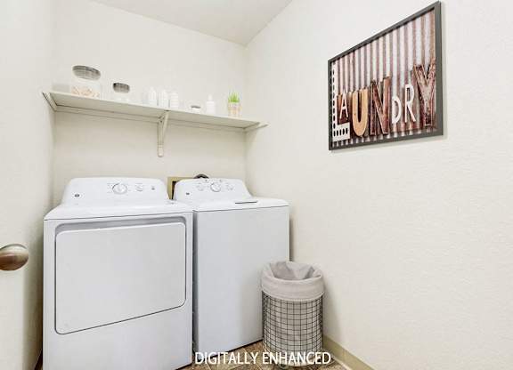 A laundry room with a washer and dryer and a shelf at Tanglewood Apartments, Oak Creek
