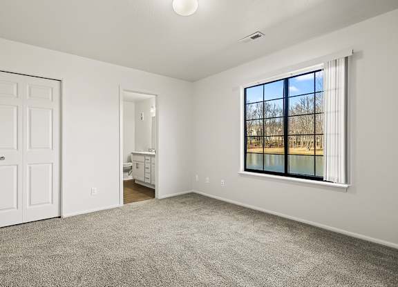 A bedroom with an attached bathroom and a closet at Tanglewood Apartments, Oak Creek, WI