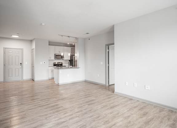 A spacious kitchen with a breakfast bar and a dining area.