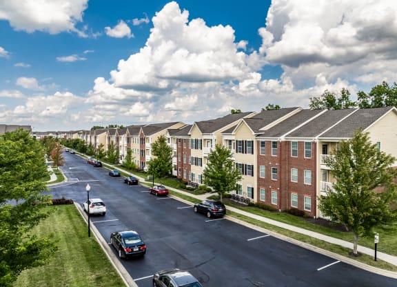 an aerial view of an apartment complex with cars parked on a street at The Avenue at Polaris Apartments, Ohio