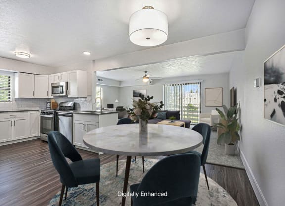 an open kitchen and dining room with hard surface floors at The Crossings Apartments, Michigan, 49508