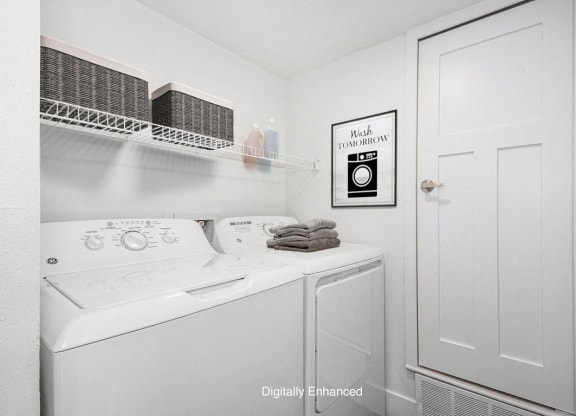 a laundry room with a washer and dryer at The Crossings Apartments, Michigan, 49508