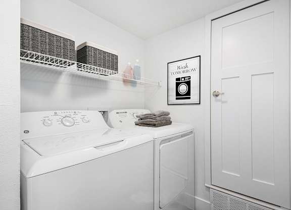 a laundry room with a washer and dryer at The Crossings Apartments, Michigan, 49508