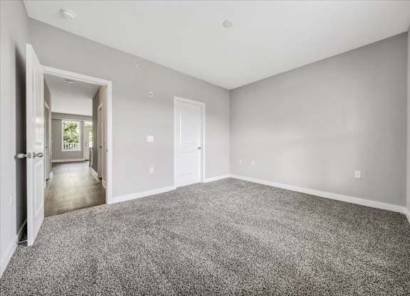 A spacious room with grey carpeting and white walls at The Retreat Apartments, Roanoke, 24019