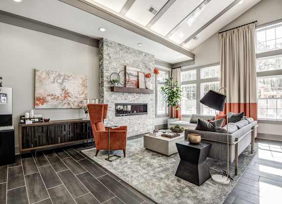 A modern living room with a fireplace and a large painting on the wall at The Retreat Apartments, Roanoke, 24019