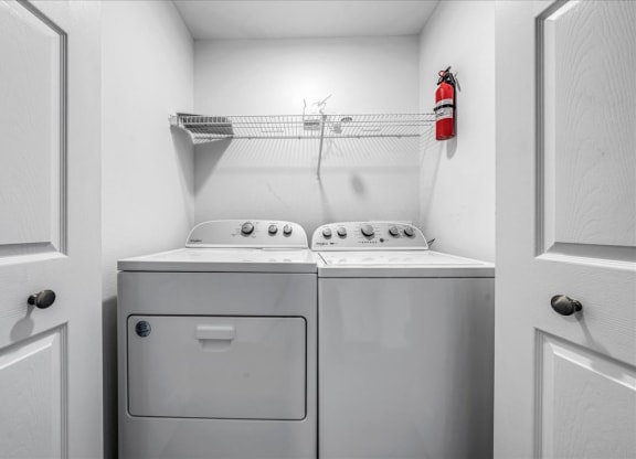 a washer and dryer in a laundry room with a fire hydrant at The Vinings Apartments in Richmond, VA 