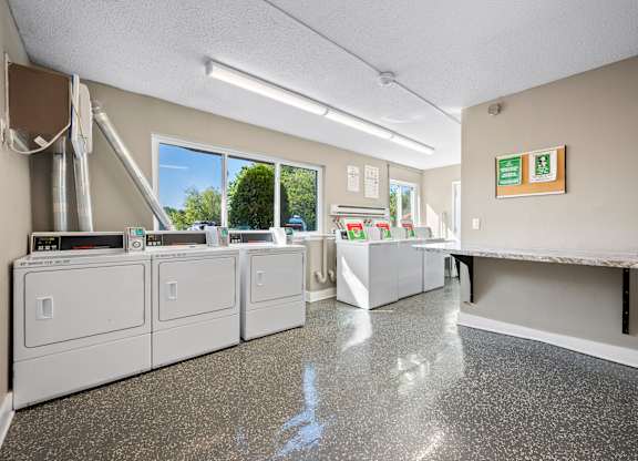 A clean, empty laundromat with washers and dryersk at Timberlane Apartments, Peoria, Illinois