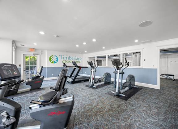 A gym with treadmills and elliptical machinesk at Timberlane Apartments, Peoria, Illinois