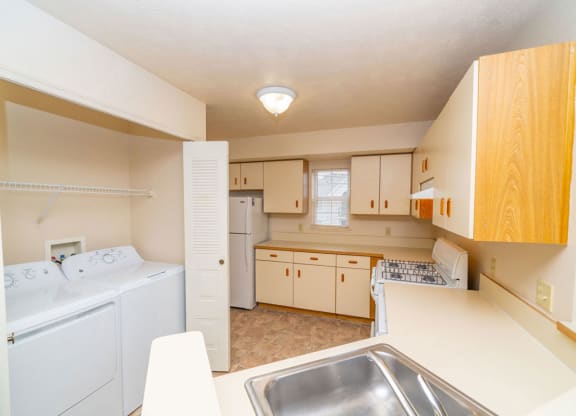 kitchen with a window and washer/dryer at Tracy Creek Apartment Homes, Ohio