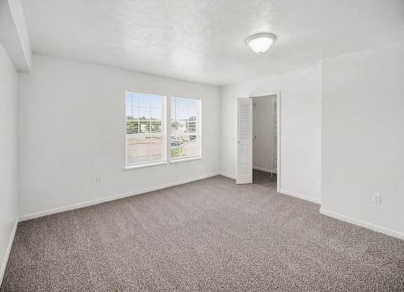 A spacious bedroom with a walk-in closet and a window at Tracy Creek Apartments, Ohio