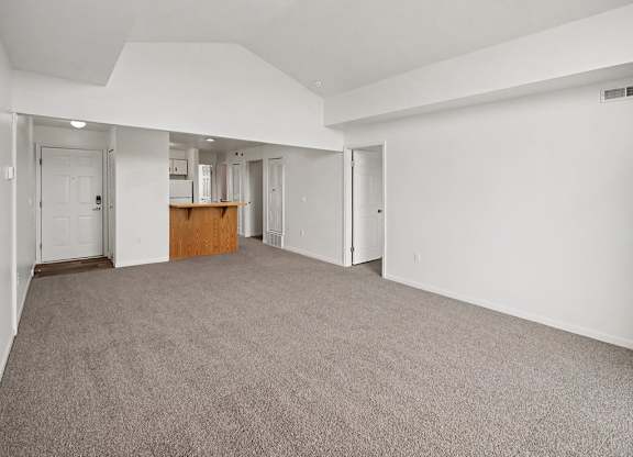 A large, empty dining room with a carpeted floor and white walls at Tracy Creek Apartments, Ohio