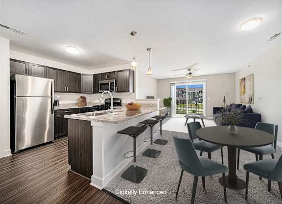 an open kitchen and living room with a stainless steel appliances at Trade Winds Apartment Homes, Elkhorn, Nebraska
