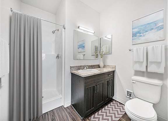 A second bathroom with a sink, toilet, and shower at Trade Winds Apartment Homes, Elkhorn, Nebraska