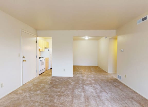 living room and dining room with breakfast bar at Trappers Cove Apartments, Lansing, Michigan
