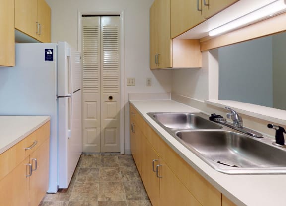 a kitchen with a pantry at Trappers Cove Apartments, Lansing, MI