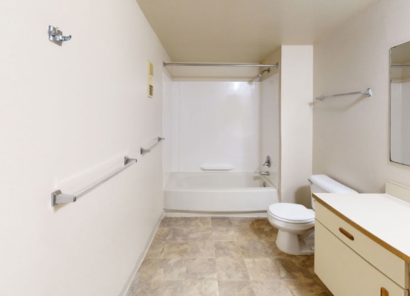 a bathroom with a sink toilet and a bath tub  at Trappers Cove Apartments, Michigan