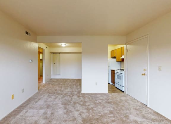 living and dining room and kitchen with plush carpet at Trappers Cove Apartments, Lansing, MI