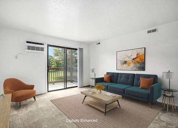 A living room with a couch, a brown chair, and a painting on the wall at Trappers Cove Apartments, Michigan, 48910