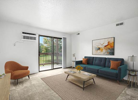 A living room with a couch, a brown chair, and a painting on the wall at Trappers Cove Apartments, Michigan, 48910