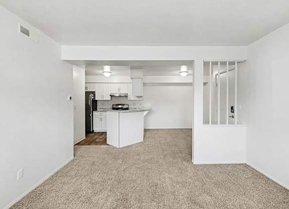 living and dining room with plush carpeting  at Trappers Cove Apartments, Lansing, MI