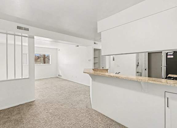 A white dining room with a breakfast bar at Trappers Cove Apartments, Lansing