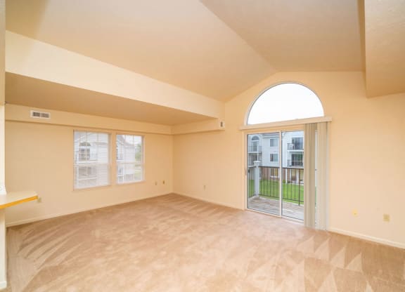 enlarged living room with a door to a patio at Trillium Pointe Apartment Homes, Jackson, MI, 49201