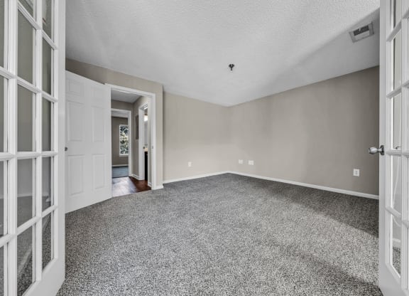 the living room of an empty house with white doors at Trophy Club at Bellgrade, Midlothian, VA, 23113