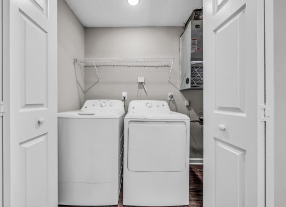 a washer and dryer in a laundry room with white appliances at Trophy Club at Bellgrade, Midlothian, VA, 23113