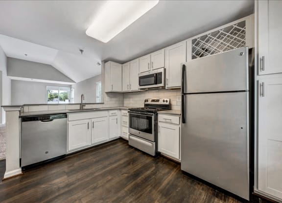 a kitchen with stainless steel appliances and white cabinets at Trophy Club at Bellgrade, Midlothian, VA, 23113