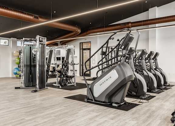 Gym with a variety of equipment including treadmills, weights, and exercise machines at Upper Vue Flats, Ohio