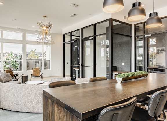 A modern dining room with a wooden table and chairs.
