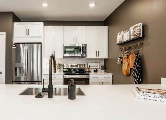 A modern kitchen with a white countertop and stainless steel appliances at Upper Vue Flats, Dublin