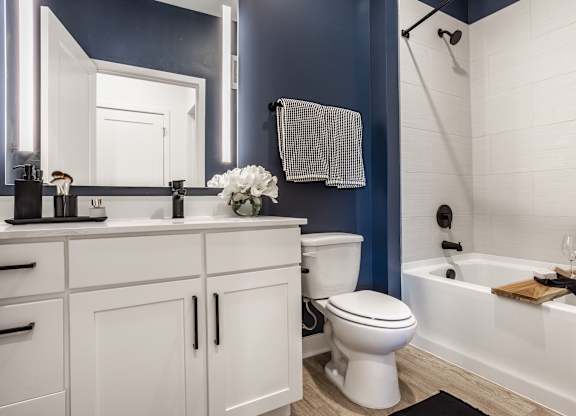 A white toilet sits in a bathroom with blue walls at Upper Vue Flats, Dublin