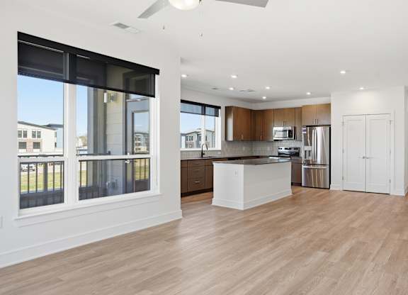 A spacious kitchen with wooden floors and white walls at Upper Vue Flats, Dublin
