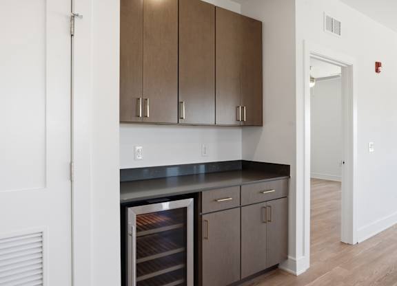A kitchen with a refrigerator, cabinets, and a counter at Upper Vue Flats, Dublin