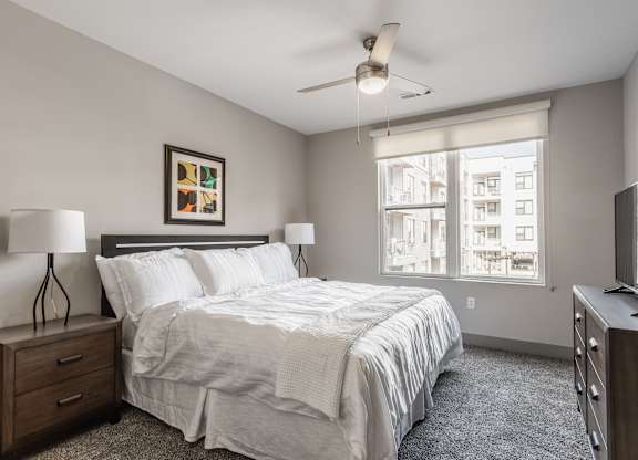 A bedroom with a large bed and a flat screen TV.