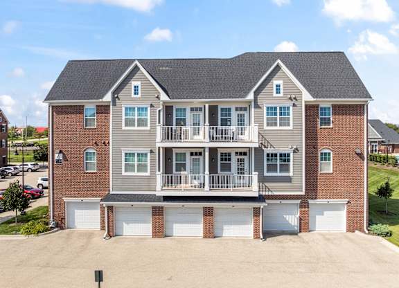 A large two-story house with a garage on the ground floor