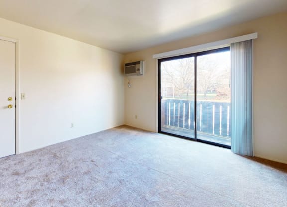living room with a sliding door to a private balcony at Walnut Trail Apartments in Portage, MI 49002